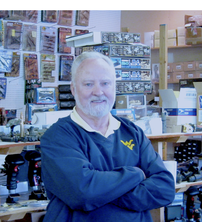 Young Bill in his workshop surrounded by plaques and military models